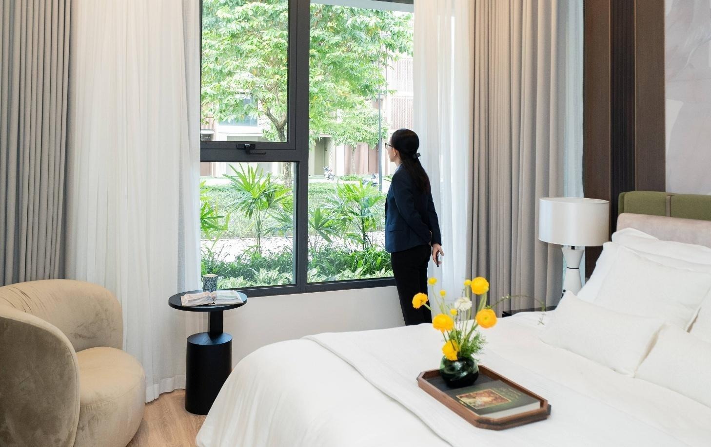 A person standing in front of a windowAI-generated content may be incorrect.